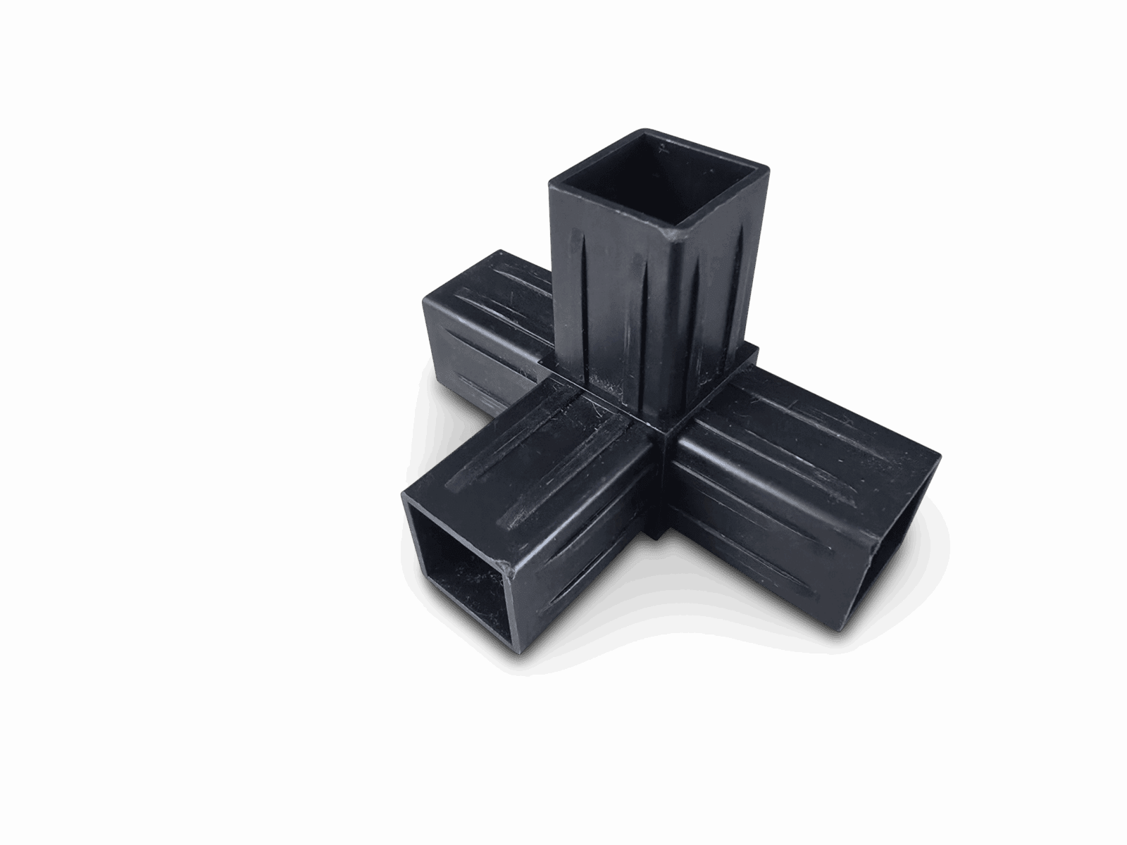 Black four-way pipe connector with square openings on a plain black background.